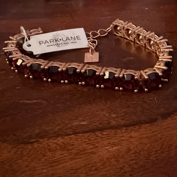 Park Lane Jewelry - Park Lane Rose Gold Bracelet With Garnet Colored Jewels